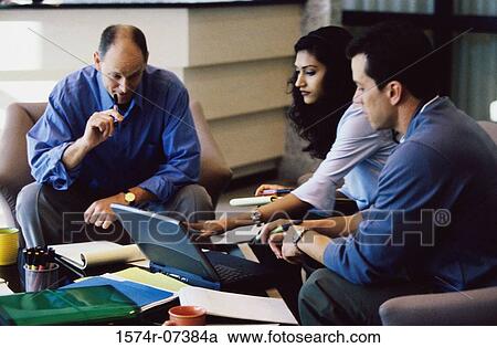 Two businessmen and a businesswoman discussing View Large Photo Image Stock Image - Two businessmen and a businesswoman discussing. Fotosearch