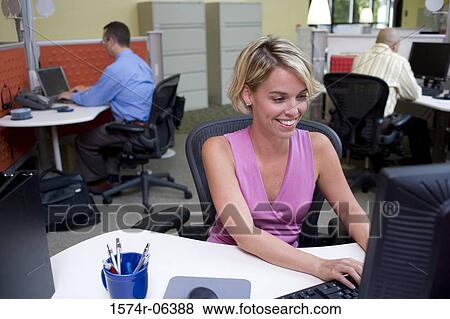 Two businessmen and a businesswoman sitting in an office View Large Photo Image Stock Photo - Two businessmen and a businesswoman sitting in an office. Fotosearch