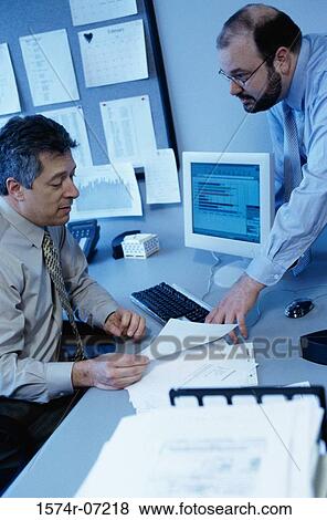 Stock Photo - Two businessmen discussing in an office. Fotosearch