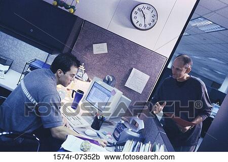 Stock Image - Two businessmen in an office. Fotosearch