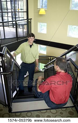 Two businessmen on a staircase View Large Photo Image Stock Image - Two businessmen on a staircase. Fotosearch