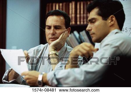 Two businessmen reading documents View Large Photo Image Stock Image - Two businessmen reading documents. Fotosearch