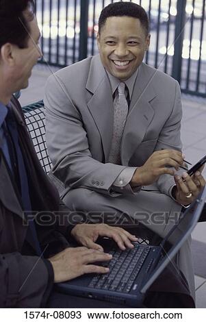 Two businessmen talking View Large Photo Image Stock Image - Two businessmen talking. Fotosearch