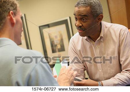 Two businessmen talking View Large Photo Image Stock Photo - Two businessmen talking. Fotosearch