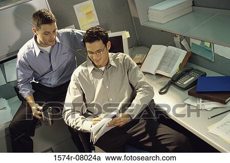 Two businessmen working in an office View Large Photo Image Stock Image - Two businessmen working in an office. Fotosearch