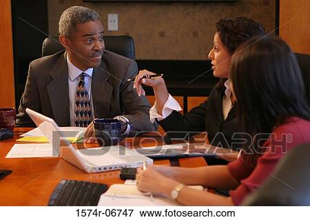 Two businesswomen and a businessman in a conference room View Large Photo Image Stock Photo - Two businesswomen and a businessman in a conference room. Fotosearch