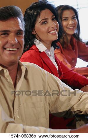 Two businesswomen and a businessman sitting in a conference room View Large Photo Image Stock Image - Two businesswomen and a businessman sitting in a conference room. Fotosearch