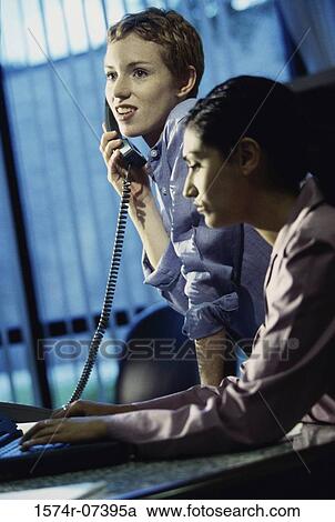 Stock Image - Two businesswomen in an office. Fotosearch