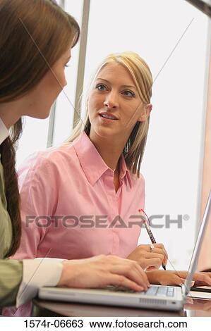 Two businesswomen looking at each other View Large Photo Image Stock Image - Two businesswomen looking at each other. Fotosearch