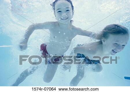 Picture - Two children swimming underwater. Fotosearch