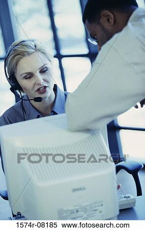 Two customer service representatives talking View Large Photo Image Stock Photography - Two customer service representatives talking. Fotosearch