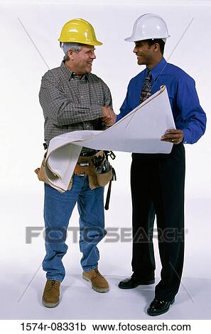 Stock Image - Two foremen shaking hands over a blueprint. Fotosearch