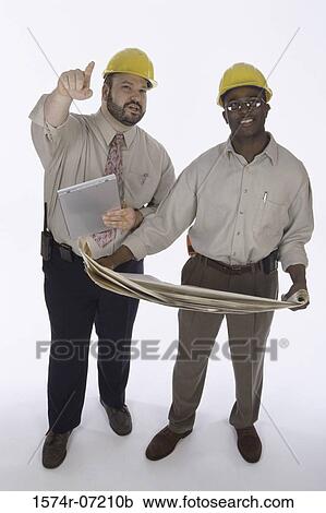 Two foremen working on blueprints View Large Photo Image Stock Image - Two foremen working on blueprints. Fotosearch