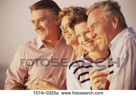 Two mature couples smiling View Large Photo Image Stock Image - Two mature couples smiling. Fotosearch