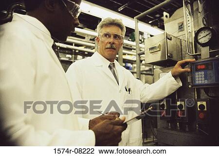 Two men working with machinery View Large Photo Image Stock Image - Two men working with machinery. Fotosearch