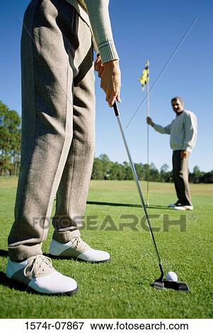Two people playing golf View Large Photo Image Stock Photo - Two people playing golf. Fotosearch