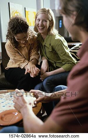 Two young women and a young man playing scrabble View Large Photo Image Stock Image - Two young women and a young man playing scrabble. Fotosearch
