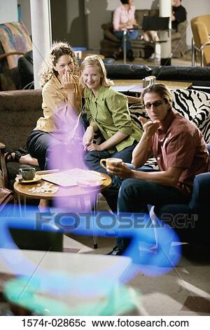 Two young women and a young man sitting in a cafeteria playing scrabble View Large Photo Image Stock Image - Two young women and a young man sitting in a cafeteria playing scrabble. Fotosearch