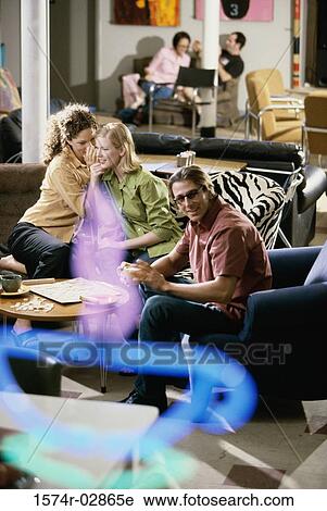 Two young women and a young man sitting in a cafeteria playing scrabble View Large Photo Image Stock Image - Two young women and a young man sitting in a cafeteria playing scrabble. Fotosearch