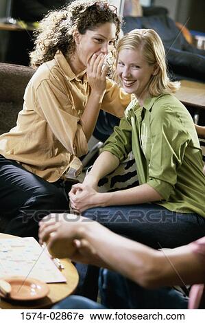 Two young women and a young man sitting in a cafeteria View Large Photo Image Stock Image - Two young women and a young man sitting in a cafeteria. Fotosearch