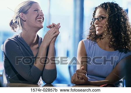 Two young women smiling View Large Photo Image Stock Image - Two young women smiling. Fotosearch
