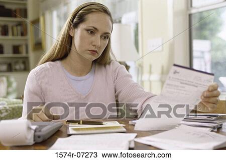 Woman reading a sheet of paper View Large Photo Image Stock Image - Woman reading a sheet of paper. Fotosearch