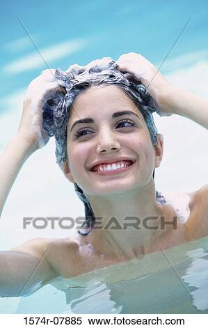 Woman washing her hair in a swimming pool View Large Photo Image Stock Photography - Woman washing her hair in a swimming pool. Fotosearch