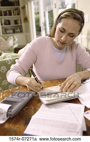 Woman writing a check View Large Photo Image Stock Image - Woman writing a check. Fotosearch