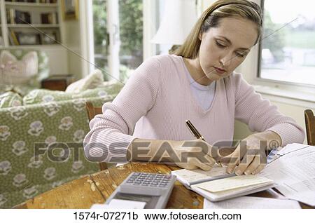 Woman writing a check View Large Photo Image Stock Image - Woman writing a check. Fotosearch