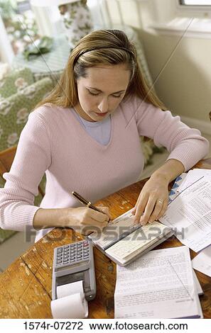 Stock Image - Woman writing a check. Fotosearch