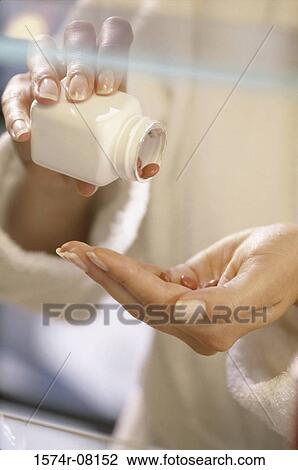 Woman's hand holding a bottle of pills View Large Photo Image Stock Image - Woman's hand holding a bottle of pills. Fotosearch