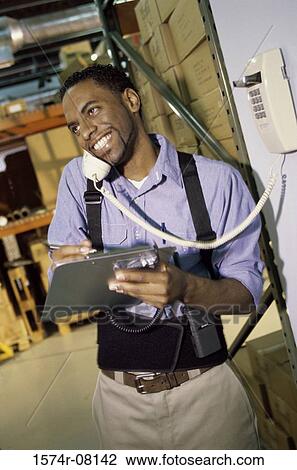 Stock Image - Worker talking on a telephone. Fotosearch