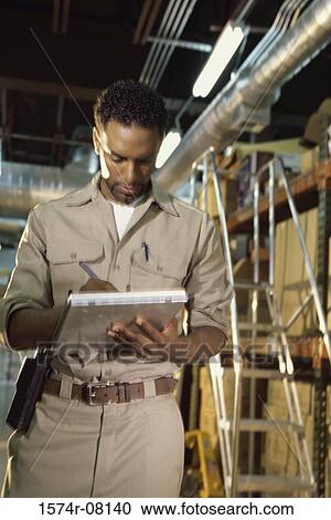 Worker writing on a clipboard View Large Photo Image Stock Image - Worker writing on a clipboard. Fotosearch