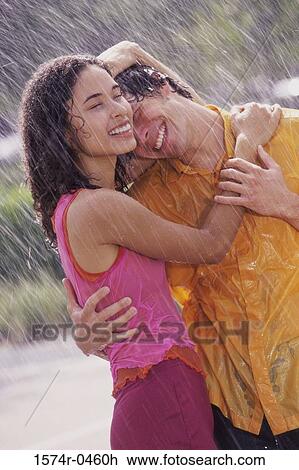 Young couple standing in the rain View Large Photo Image Stock Image - Young couple standing in the rain. Fotosearch