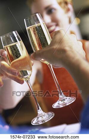Stock Image - Young couple toasting with Champagne. Fotosearch