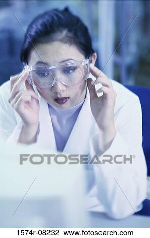 Stock Image - Young female researcher working on a computer. Fotosearch