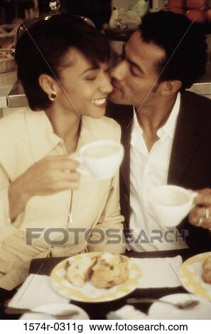 Young man kissing a young woman on the cheek View Large Photo Image Stock Image - Young man kissing a young woman on the cheek. Fotosearch