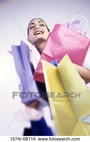 Picture - Young woman carrying shopping bags. Fotosearch