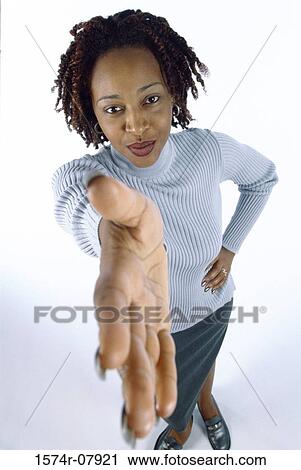 Young woman holding out her hand View Large Photo Image Stock Image - Young woman holding out her hand. Fotosearch