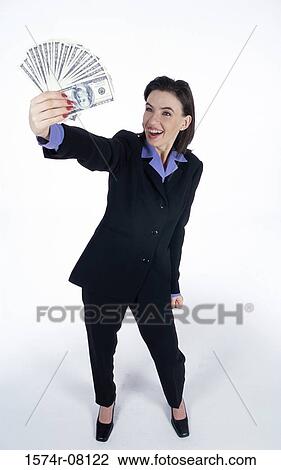 Stock Image - Young woman holding paper money. Fotosearch