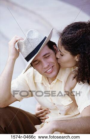 Stock Image - Young woman kissing a young man. Fotosearch