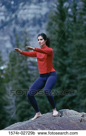 Young woman performing yoga outdoors View Large Photo Image Stock Image - Young woman performing yoga outdoors. Fotosearch