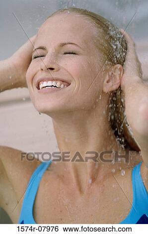 Young woman rinsing off View Large Photo Image Stock Photograph - Young woman rinsing off. Fotosearch