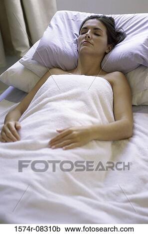 Young woman sleeping in a bed View Large Photo Image Stock Image - Young woman sleeping in a bed. Fotosearch