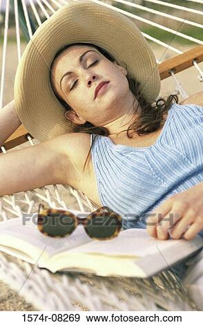 Young woman sleeping in a hammock View Large Photo Image Stock Photo - Young woman sleeping in a hammock. Fotosearch