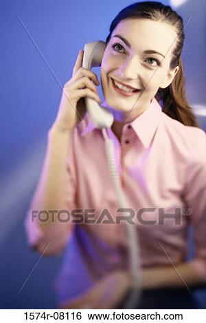 Stock Photograph - Young woman talking on a telephone. Fotosearch