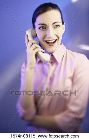 Young woman talking on a telephone View Large Photo Image Stock Photography - Young woman talking on a telephone. Fotosearch