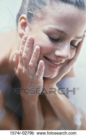 Young woman washing her face View Large Photo Image Stock Image - Young woman washing her face. Fotosearch
