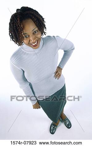 Stock Image - Young woman with her hand on her waist. Fotosearch