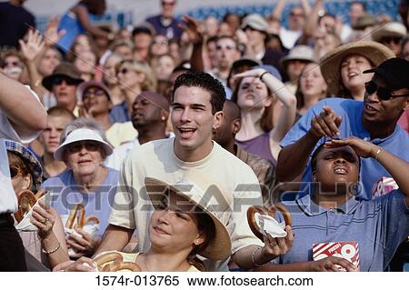 Audience in a stadium holding pretzels View Large Photo Image Stock Photography - Audience in a stadium holding pretzels. Fotosearch